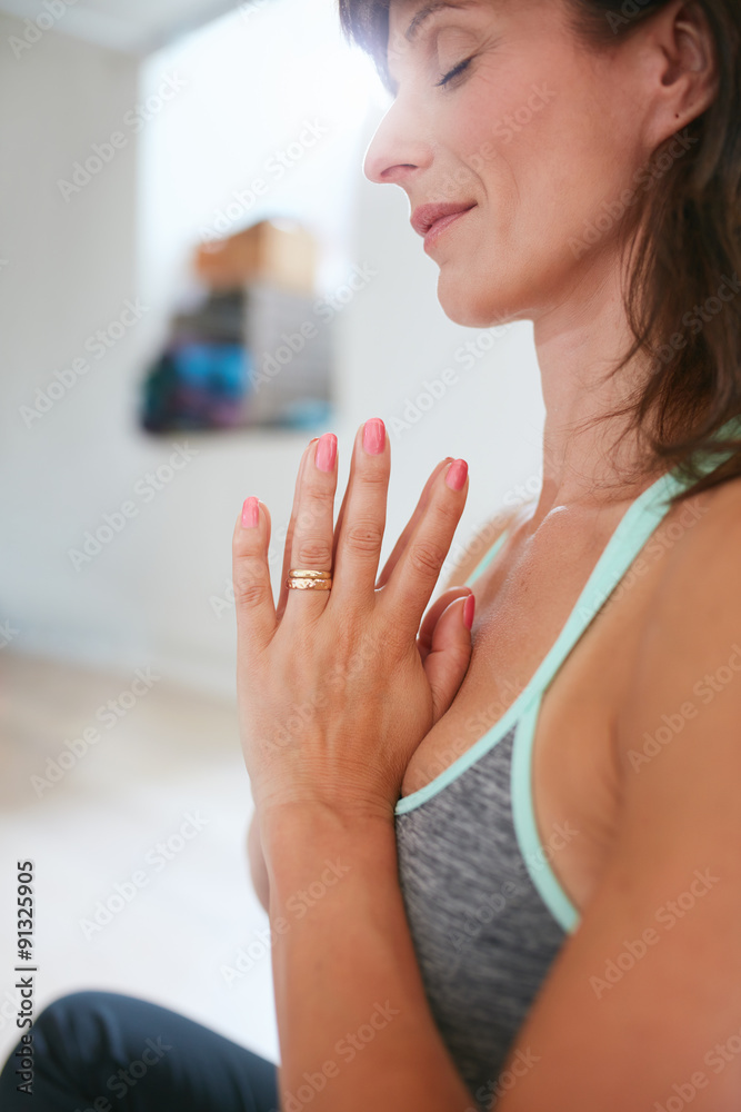 Woman practicing yoga in prayer position Woman practicing yoga in prayer position
