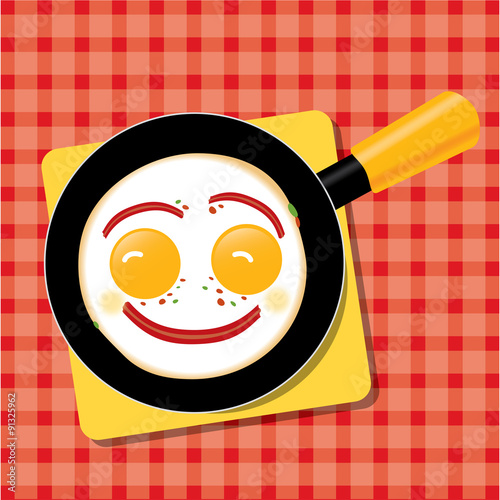 Smiling scrambled eggs with bacon in a pan for breakfast.