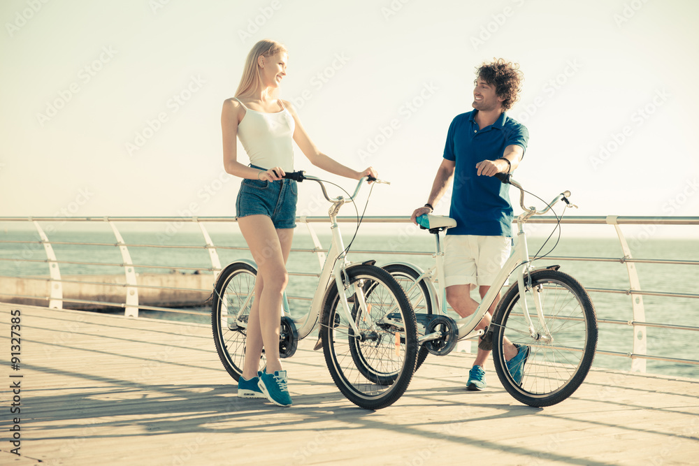 Woman and man on bicycle talkign outdoors