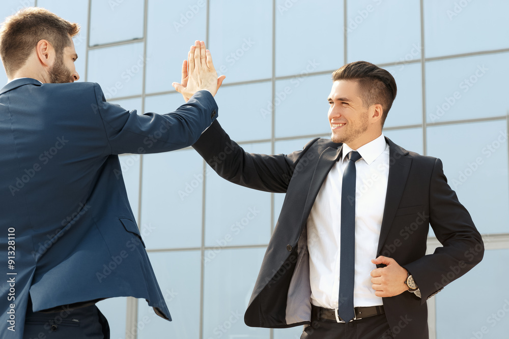 Two business colleagues high-fiving Two business colleagues high-fiving