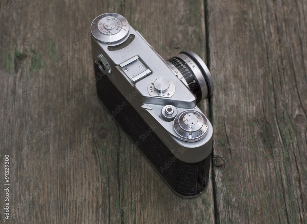the ancient film camera on an old wooden table the ancient film camera on an old wooden table