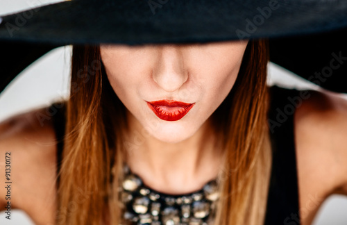 Portrait of young pretty women in black hat