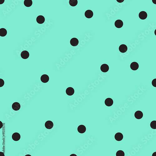 Vector seamless pattern with small black polka dots on the soft green background. 