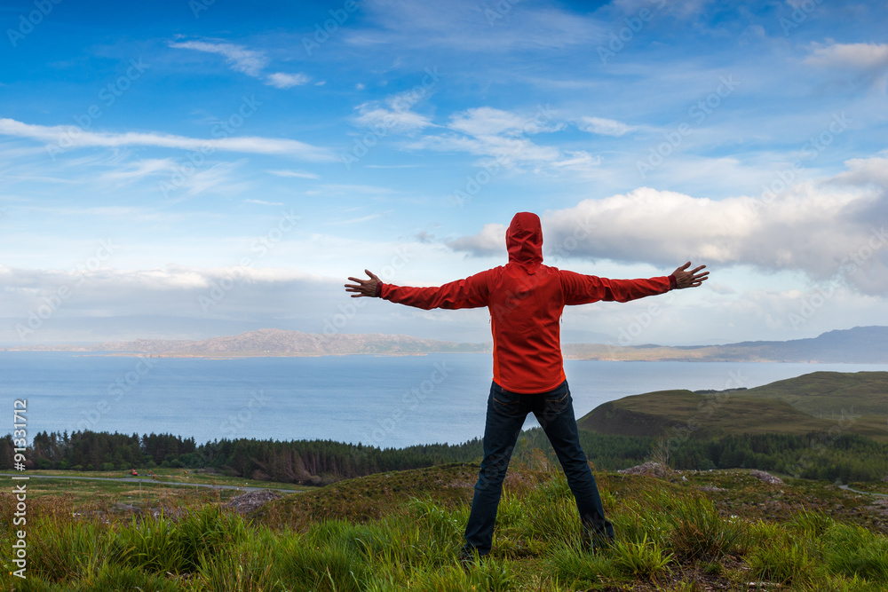 Man jumping on the top pf a mountain, Skye, Scotland