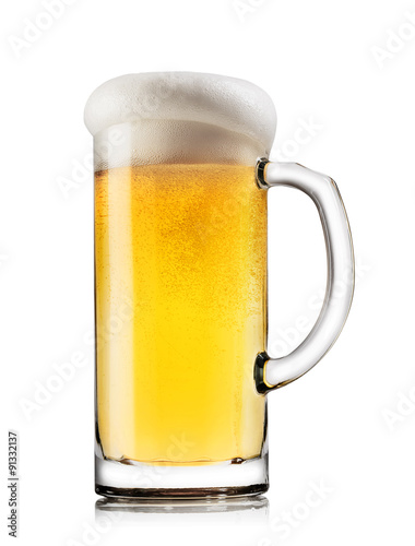 Light beer with the foam in mug