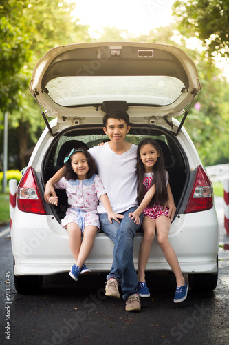 Happy Asian family sitting in the car © RedcupStudio
