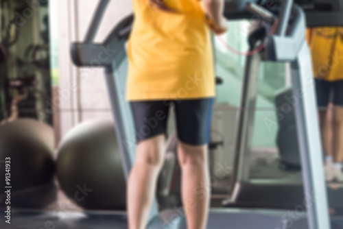 Motion blur of woman in yellow shirts and black sport shorts run