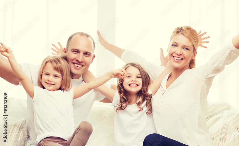 smiling parents and two little girls at new home