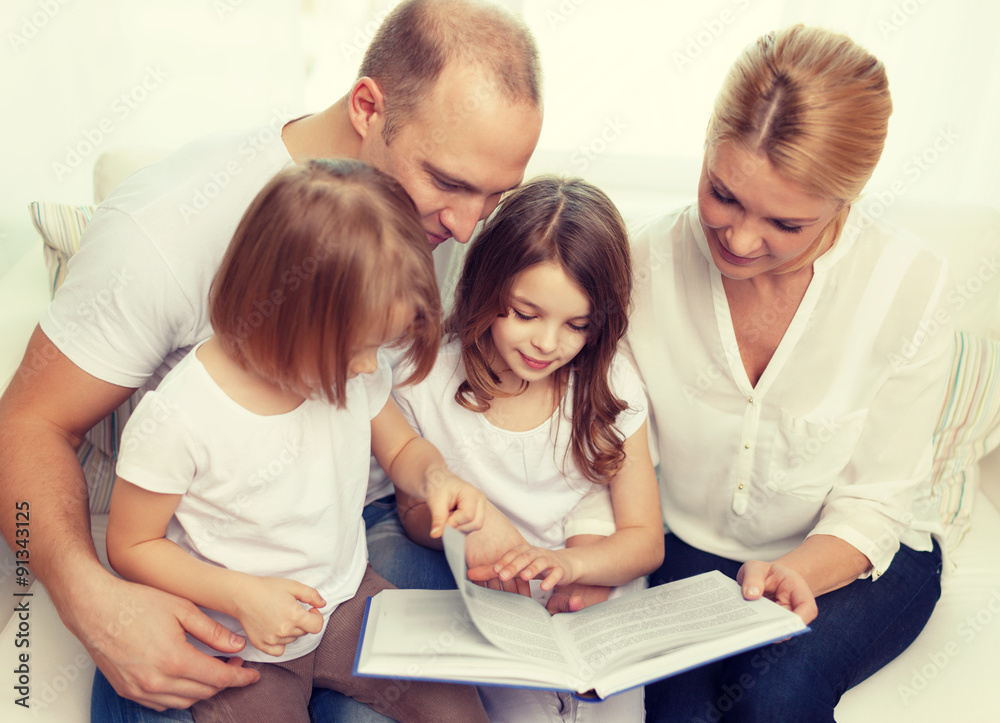 smiling family and two little girls with book