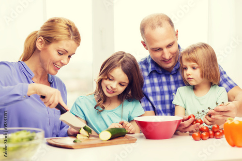 happy family with two kids making dinner at home © Syda Productions