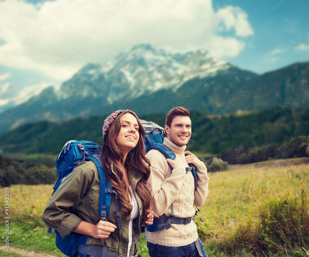 smiling couple with backpacks hiking smiling couple with backpacks hiking