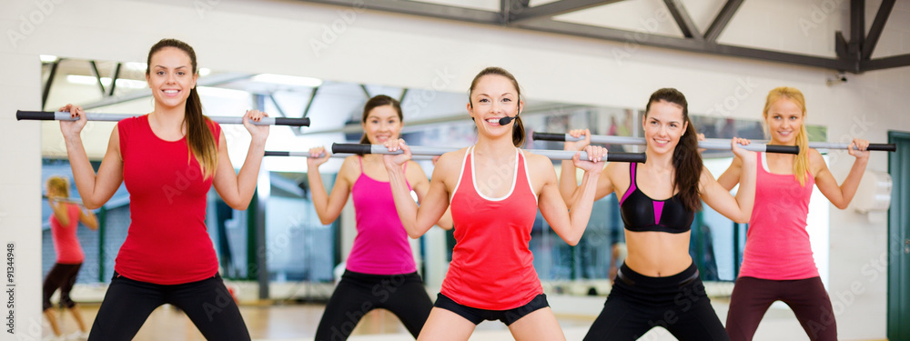 group of smiling people working out with barbells group of smiling people working out with barbells