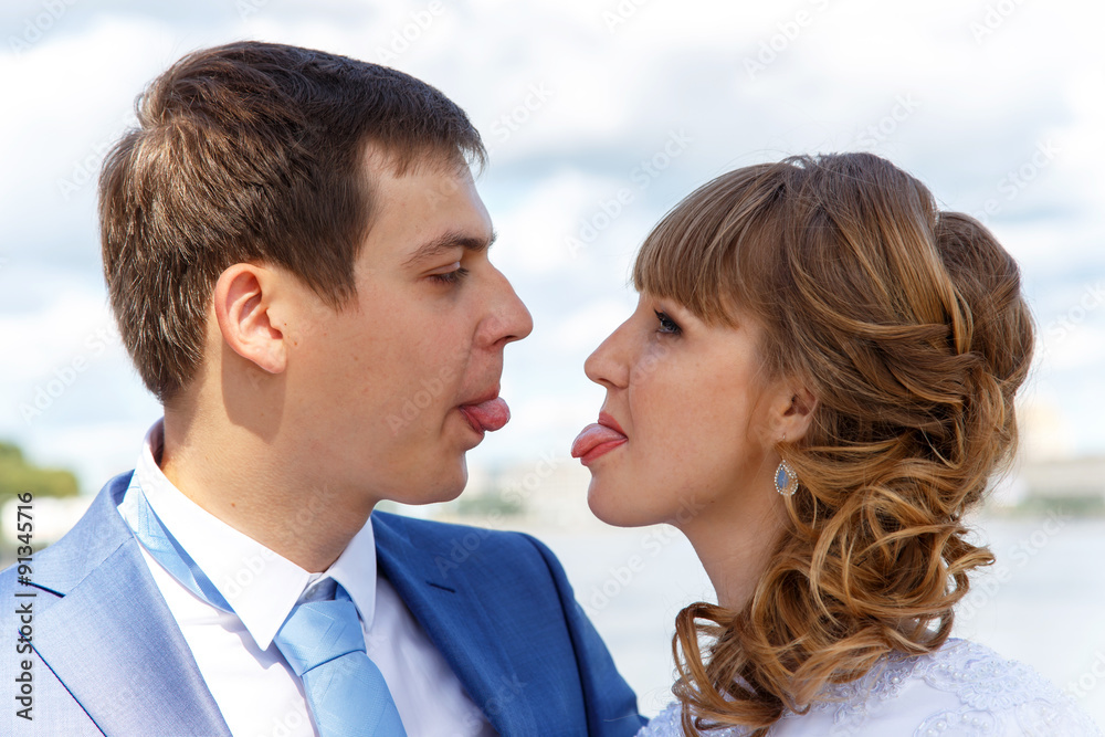 Young husband and wife show tongue to each other Young husband and wife show tongue to each other