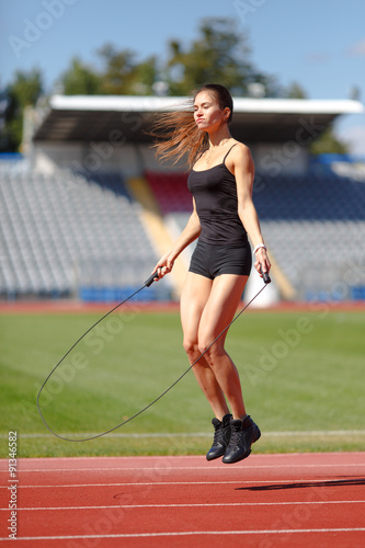 Athlete doing jump exercise on the stadium © Glebstock