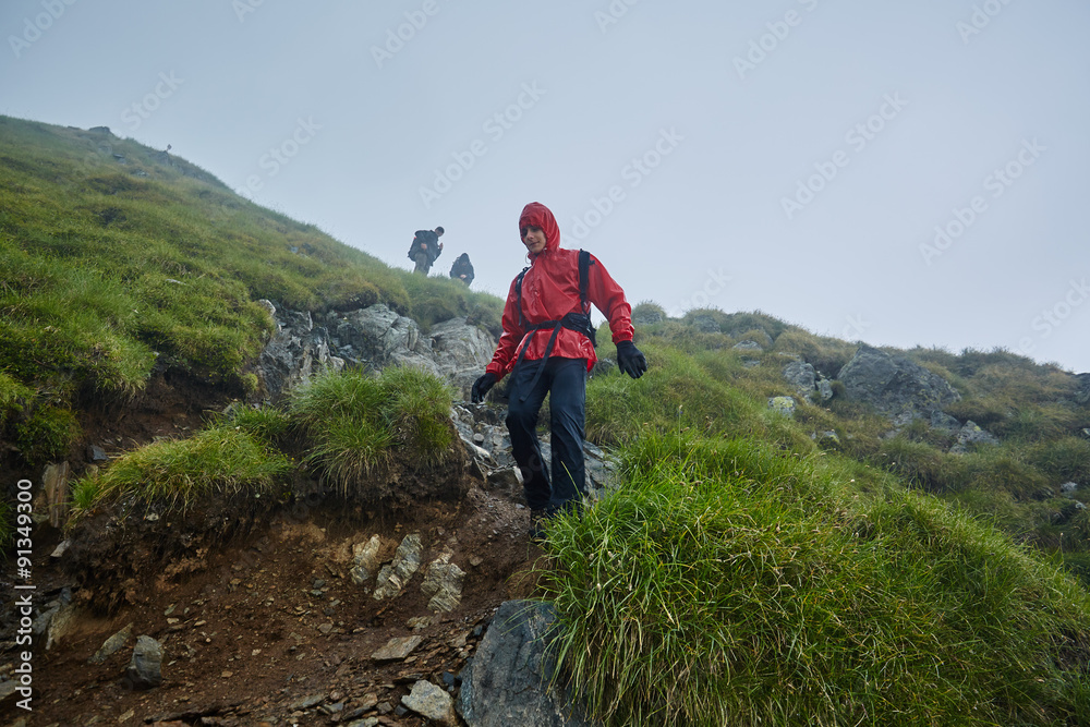 Hikers in raincoats on mountain