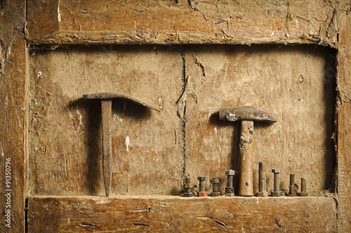 old hand tools on antique wooden panel