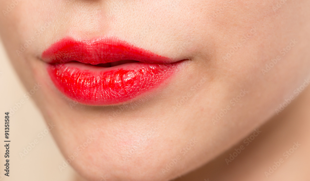 Close-up shot of woman lips with glossy red lipstick Close-up shot of woman lips with glossy red lipstick