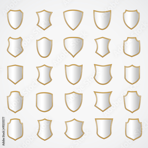 Silver shield design set with various shapes.