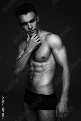 Young fashion topless man isolated on dark background