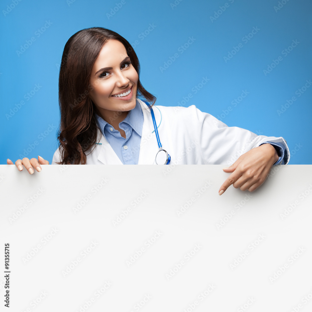 female doctor showing blank signboard, over blue female doctor showing blank signboard, over blue