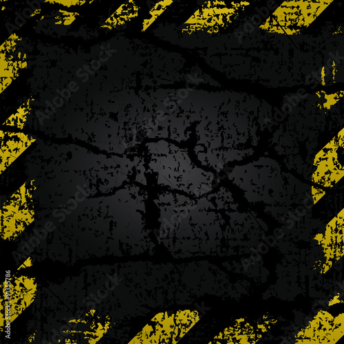 vector old shabby frame with yellow and black stripes danger warning on a background of old cracked asphalt