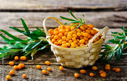 berries of an organic sea-buckthorn in a basket photo