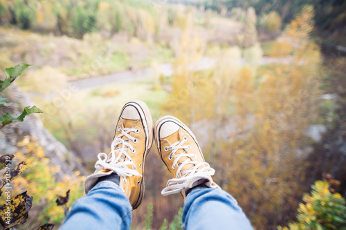 legs on mountain peak rock