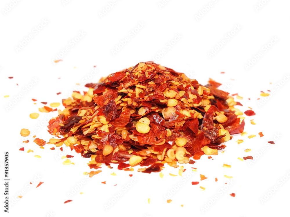 pile crushed red pepper, dried chili flakes and seeds isolated on white background pile crushed red pepper, dried chili flakes and seeds isolated on white background