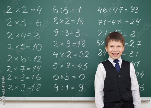 boy solve math on school board