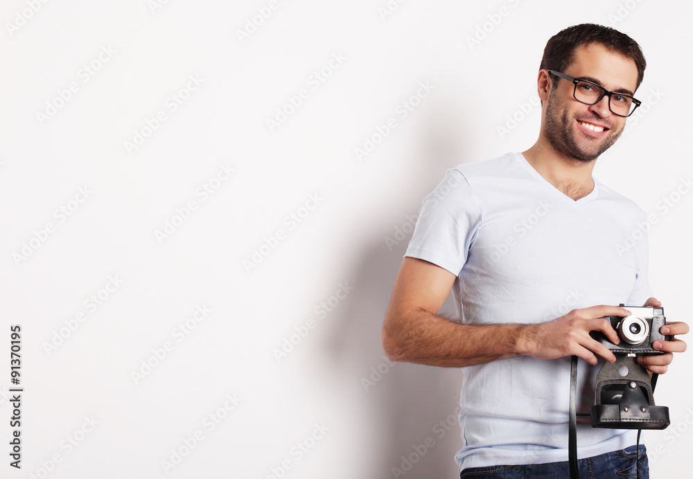 young man with a retro camera young man with a retro camera