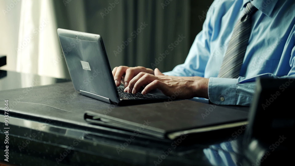 Businessman hands working on laptop in office
Businessman hands working on laptop in office