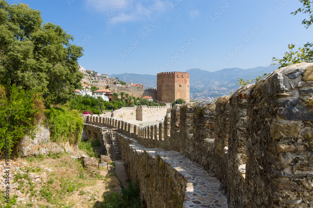 Red Tower (Kizil Kule) and the ruins of the fortress wall. The Mediterranean coast. Alanya. Turkey