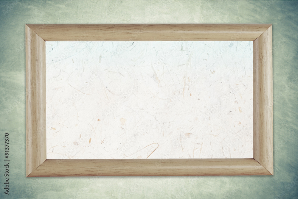 Fototapeta premium Blank wooden picture frame on grunge cement wall background