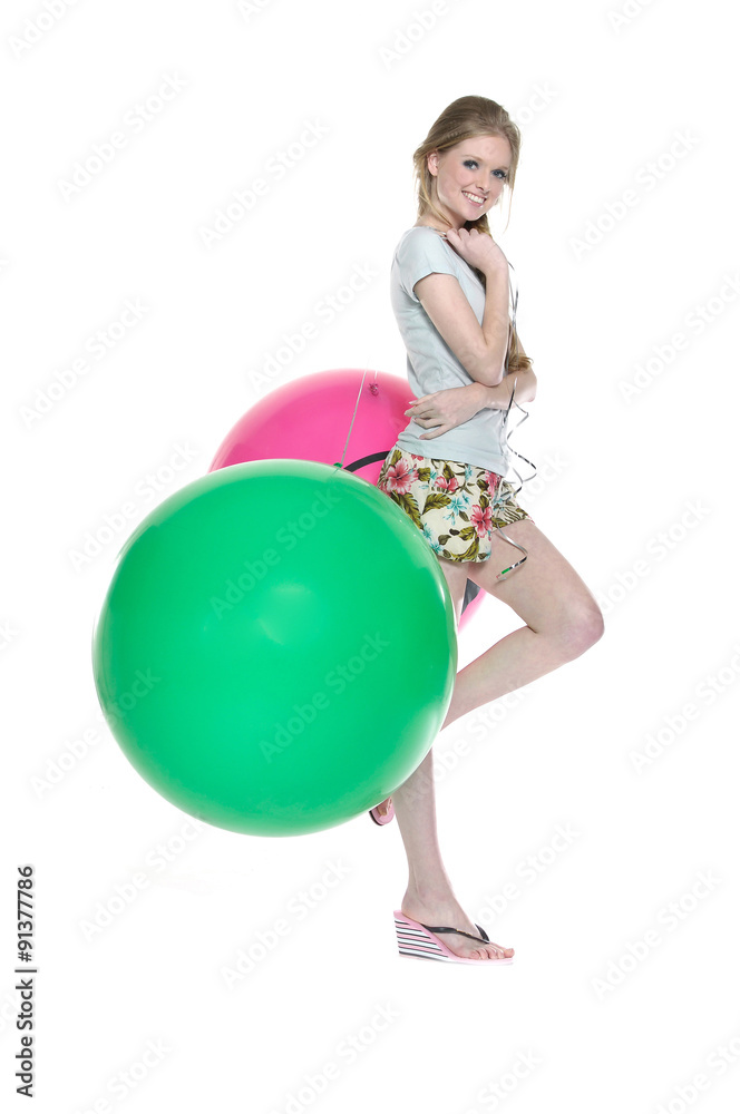 Full length young leisure woman with green and red ball posing
Full length young leisure woman with green and red ball posing