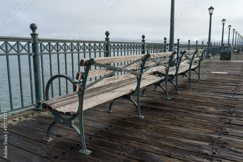 Park benches along a wooden pier © pabrady63