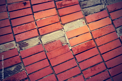 broken red tiles on old cement floor