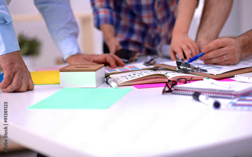 Close-up of three young creative designers working on project