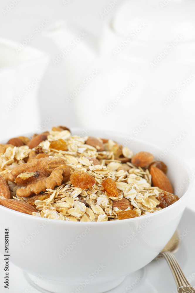 Oatmeal flakes with nuts in bowl Oatmeal flakes with nuts in bowl