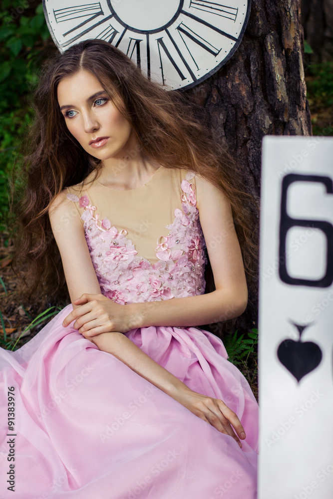 portrait of a young girl in a pink dress as Alice in Wonderland - obrazy, fototapety, plakaty 
