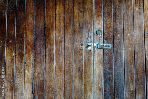 Old padlock on a wooden door © ezstudiophoto