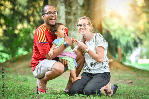 Happy interracial family is enjoying a day in the park