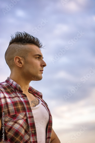 Handsome Athletic Man Looking Away Against Sky