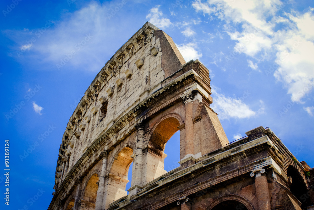 Colosseum, Flavian Amphitheatre, on a sunny day with little clouds. Rome, Italy