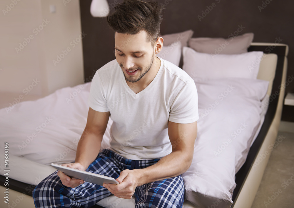 Man checking morning news on his tablet
