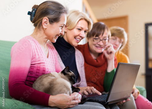 Female pensioners with laptop indoor