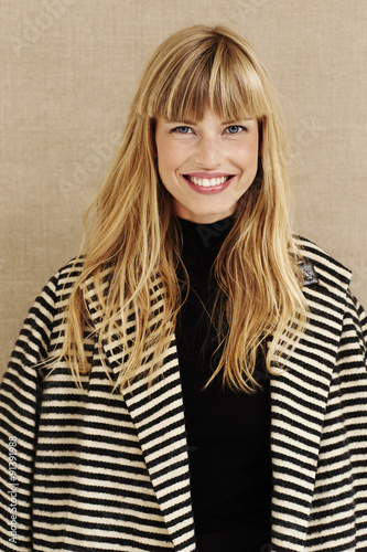 Smiling young businesswoman in studio