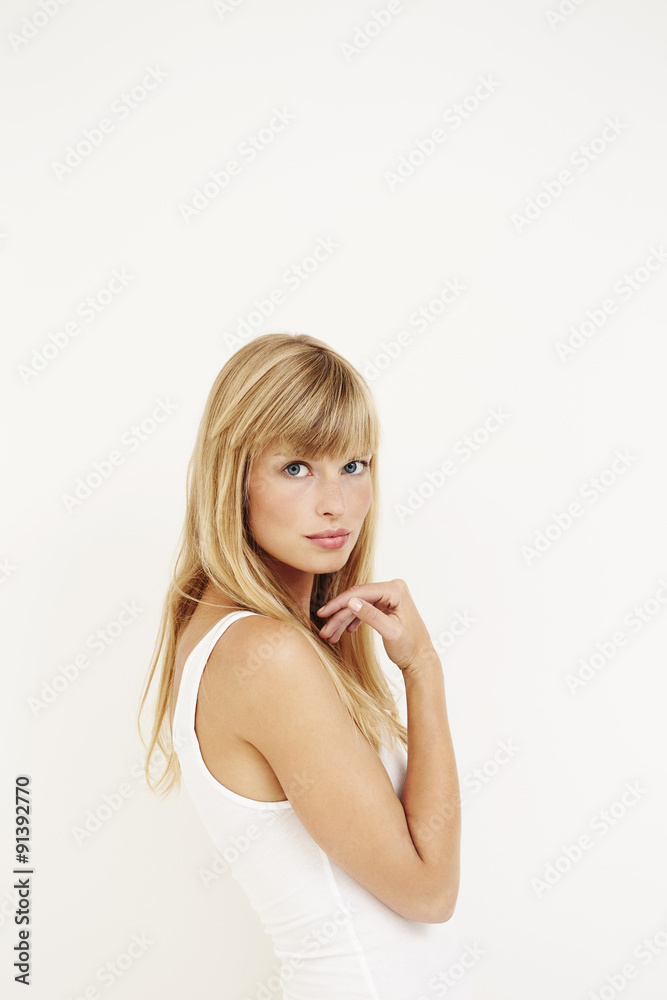 Young woman in portrait against white Young woman in portrait against white