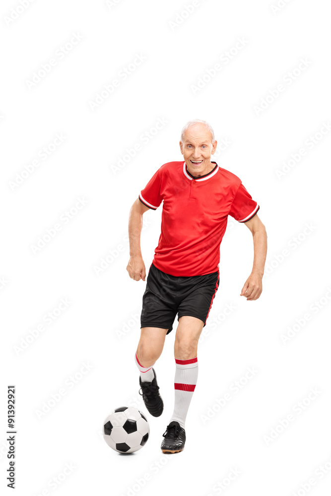 Senior man in a red jersey playing football