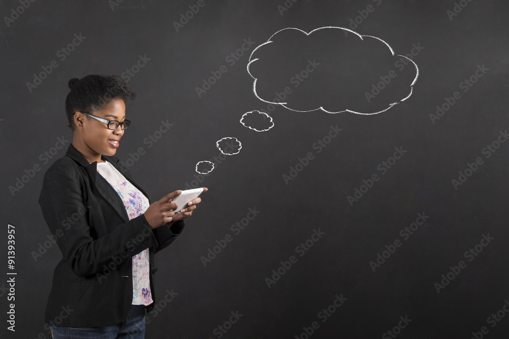 African woman with tablet speech or thought bubble on blackboard background African woman with tablet speech or thought bubble on blackboard background