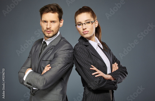 Business couple on grey background